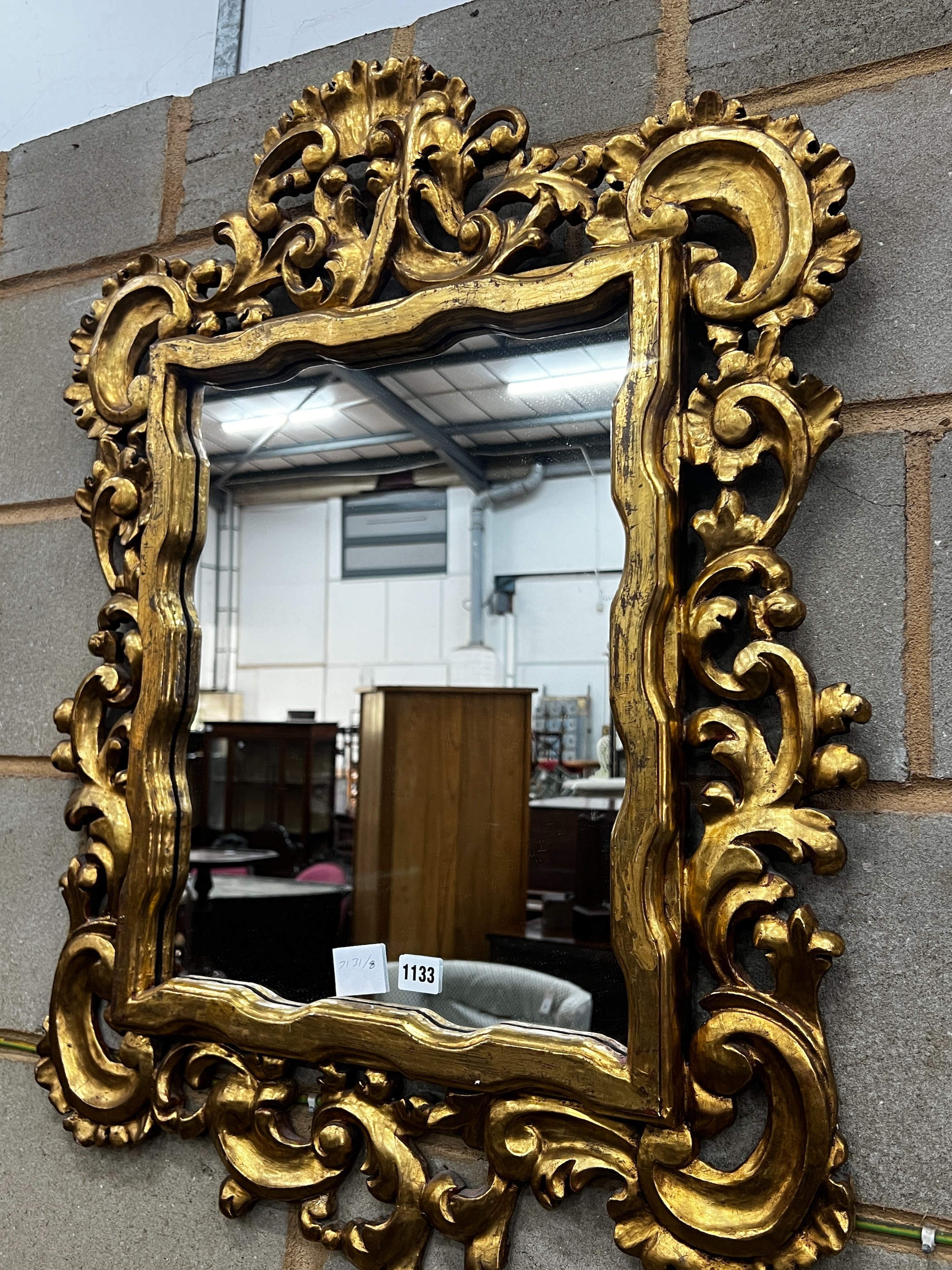 A rectangular Florentine style scrolling carved gilt framed wall mirror, width 63cm, height 90cm